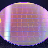 silicon wafer with microchips on black background.